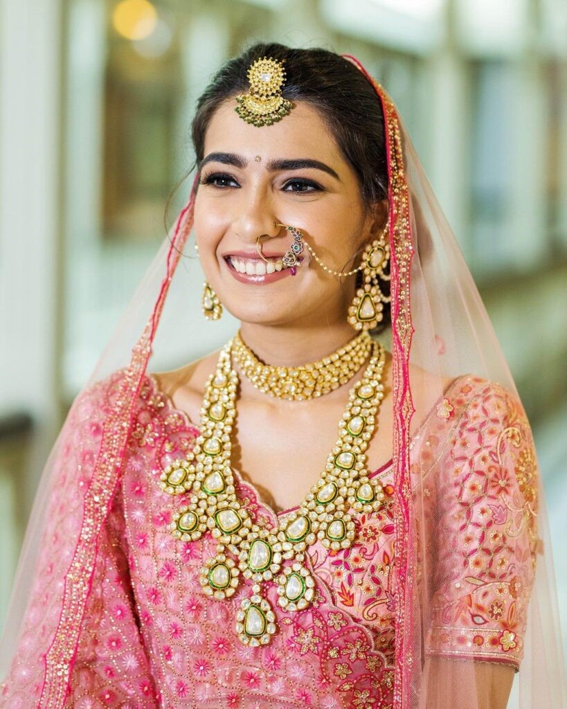 Renu looks gorgeous for her reception in a blush pink and blue lehenga.  Hair and makeup by Vejetha for Swank. MUA. Berry … | Heirloom bridal,  Bridal, Bridal jewelry
