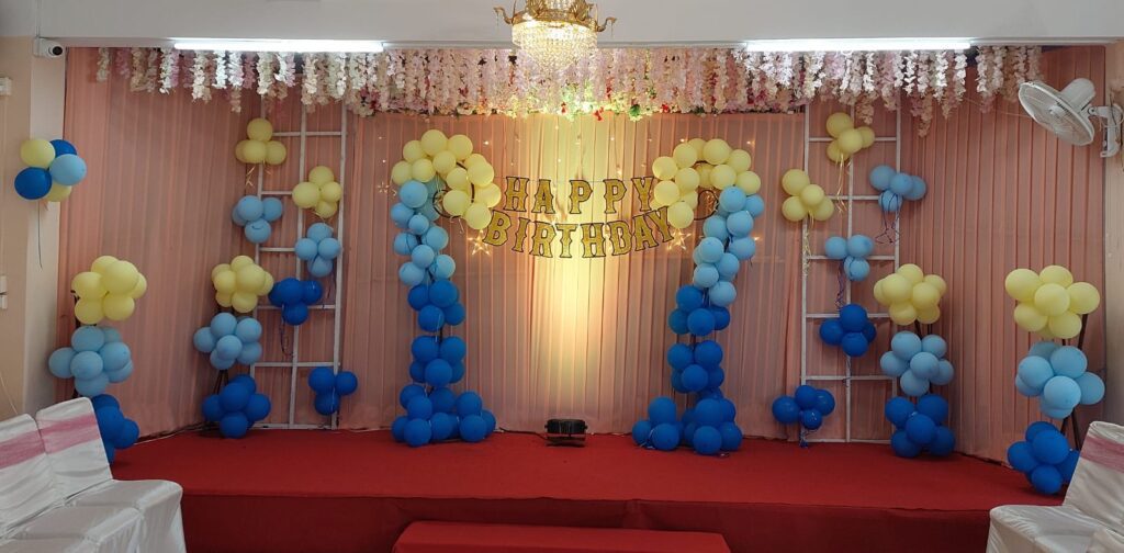Stage adorned with balloons decoration.