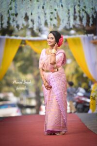 A smiling girl wearing a mekhela chador in Guwahati.