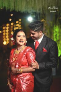 Couple striking a pose for a photograph.
