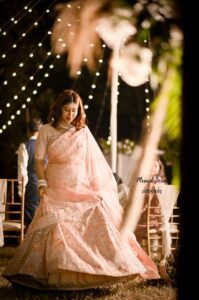 Girl is wearing a lehenga choli outfit.