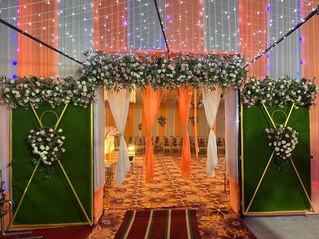 Entrance adorned with curtains and floral decorations.