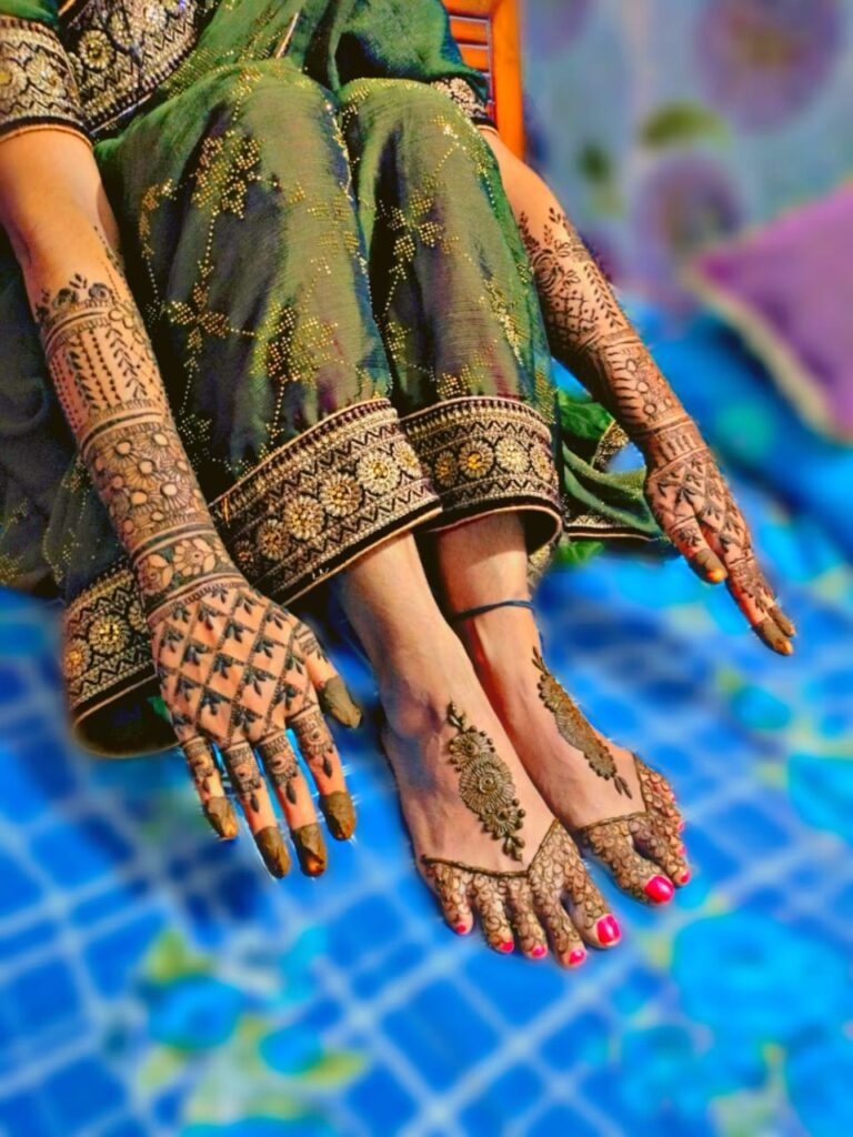 Henna designs applied on hands and feet.
