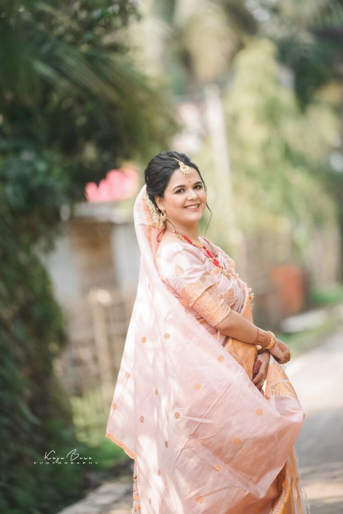A smiling girl wearing a sari.