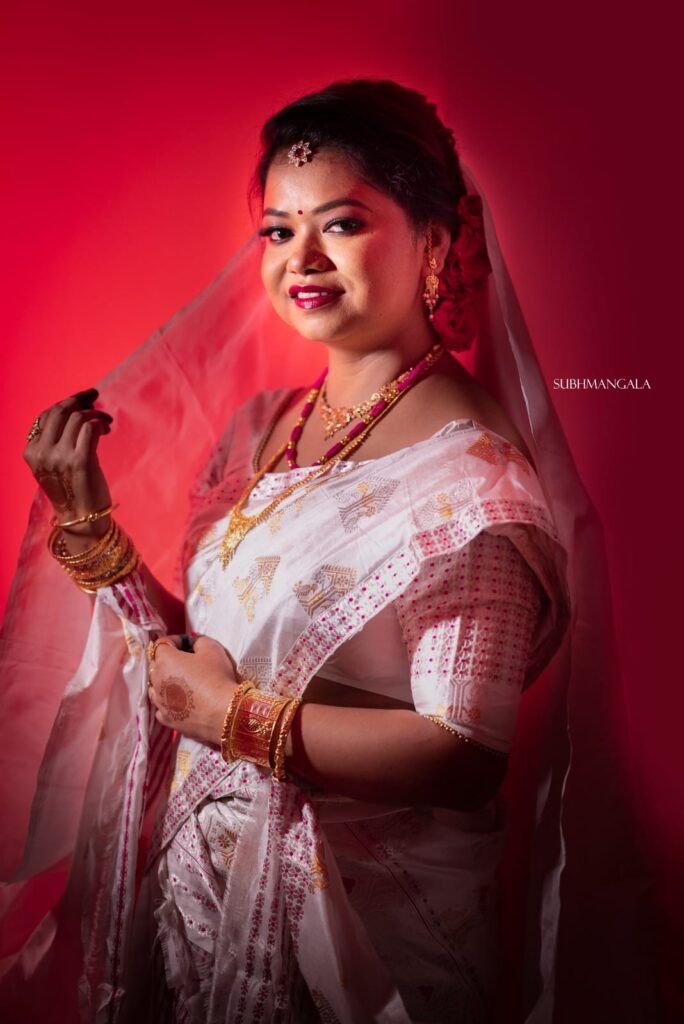 Assamese smiling girl wearing a mekhela chador.