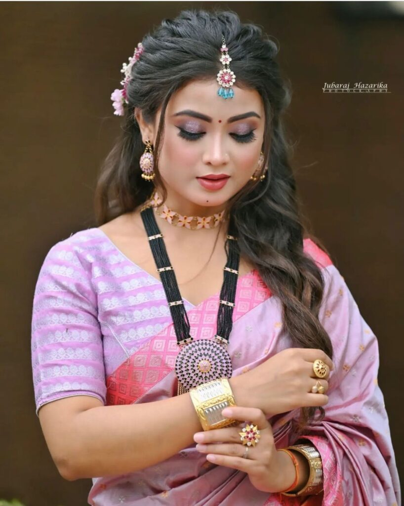 Assamese girl with makeup-enhanced face.