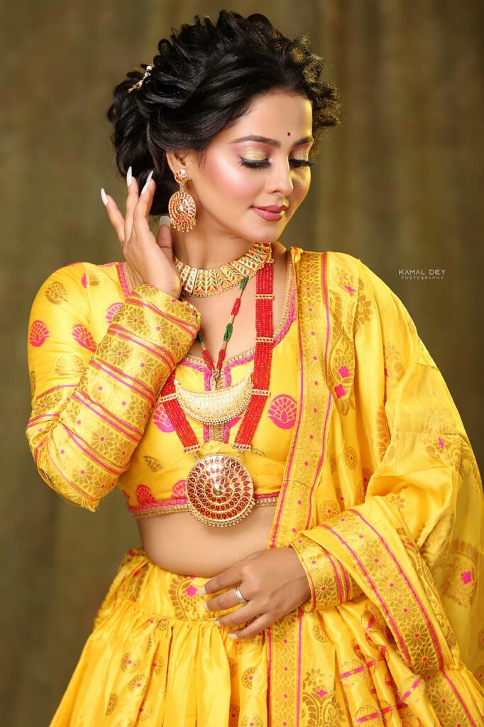 Girl wearing a lehenga choli, adorned with makeup.