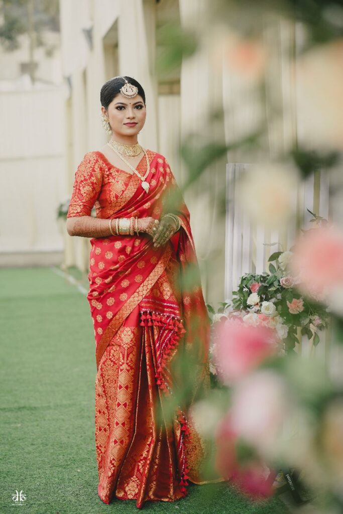 A girl wearing a saree, posing for a picture.