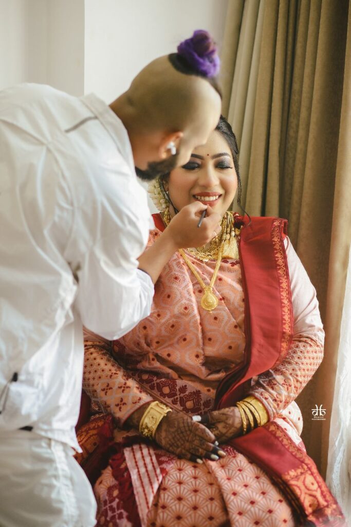 Makeup artist applying makeup to a woman.