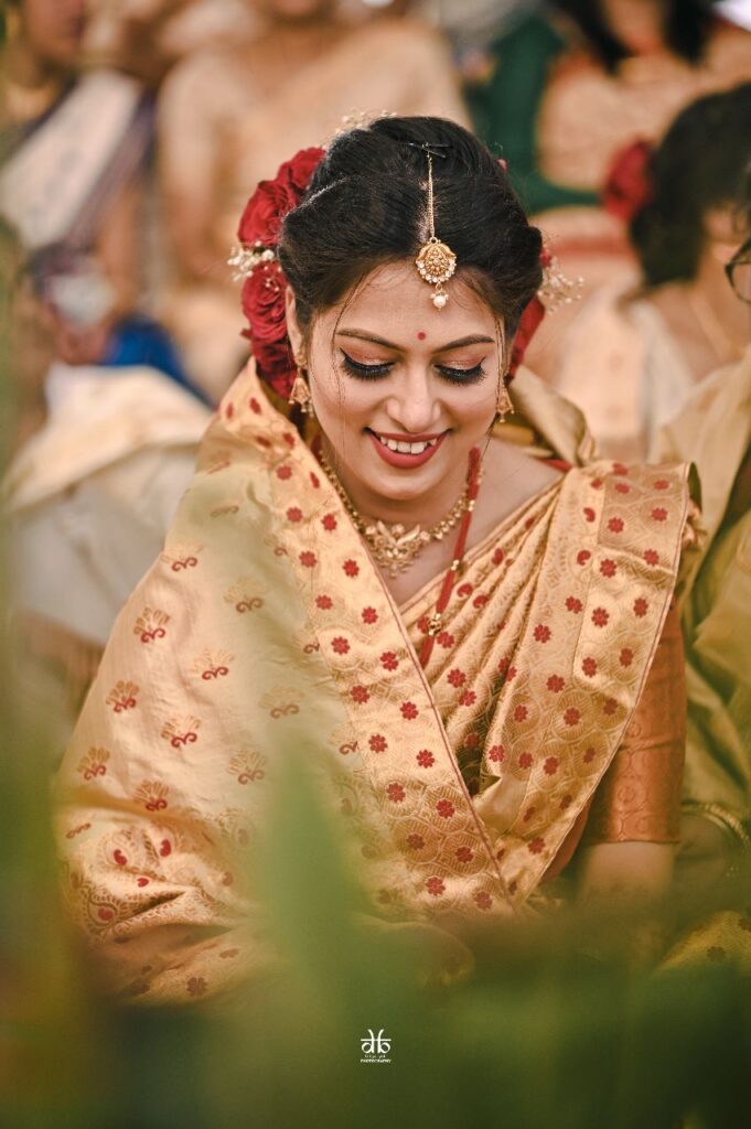 Girl smiling happily while looking downwards.