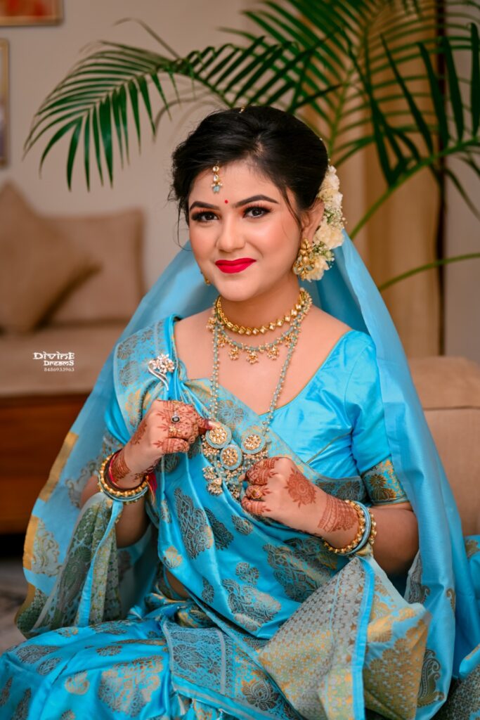 A girl wearing a blue mekhela chador in traditional style.