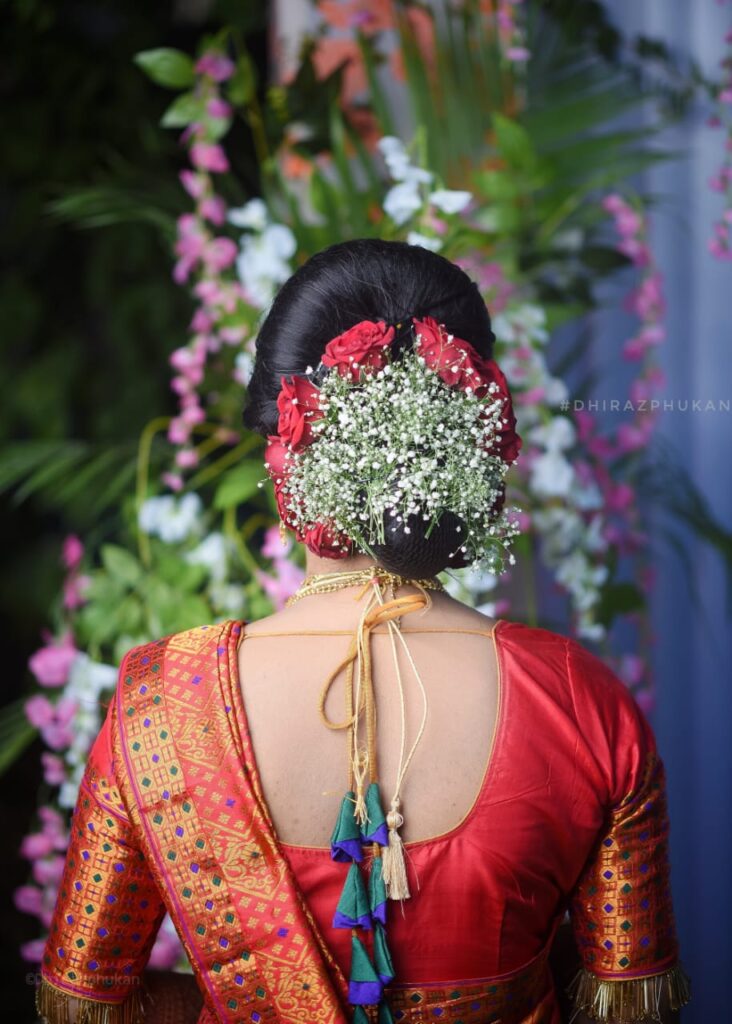 Back view of girl's hair adorned with flowers.