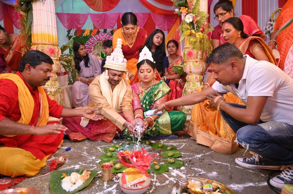 Bride and groom performing mandap rituals.