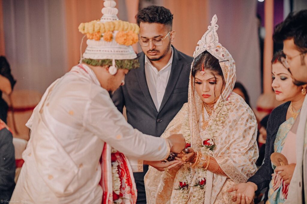 Bride and groom performing rituals at the wedding mandap.