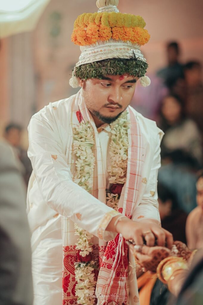 A groom in traditional wedding attire.