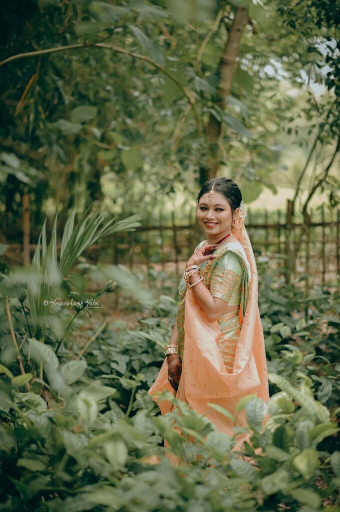 A happy bride wearing a traditional mekhela chador.