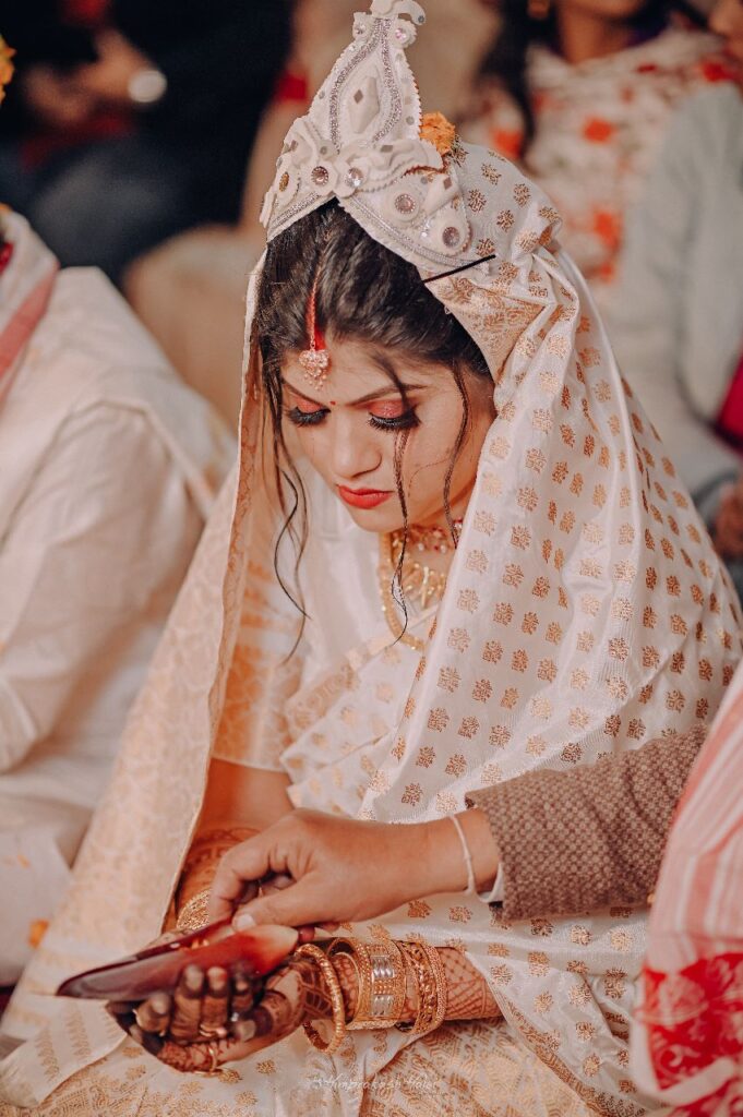 Bride seated in front of the wedding mandap.