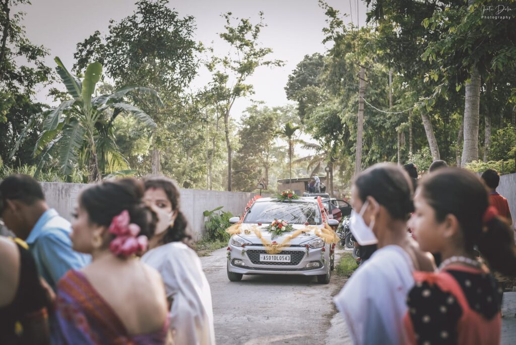 Groom's car decorated with flowers.
