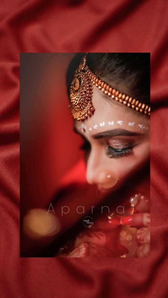 Closeup of a bride's face wearing matha patti on her forehead.