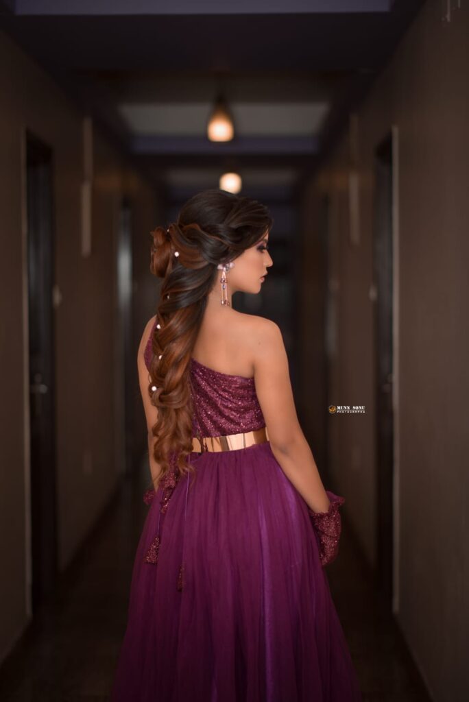 Back view of a girl wearing a purple maxi dress.