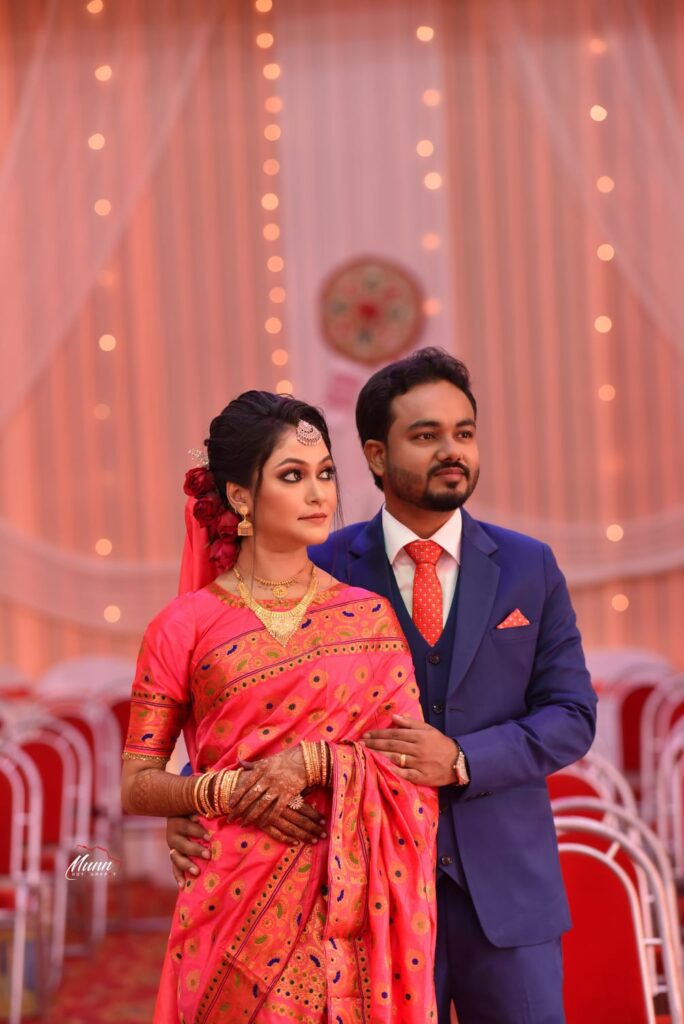 Bride and groom striking a pose for a photograph.