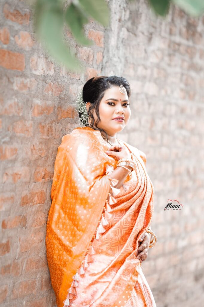 A smiling girl wearing a mekhela chador in traditional style.