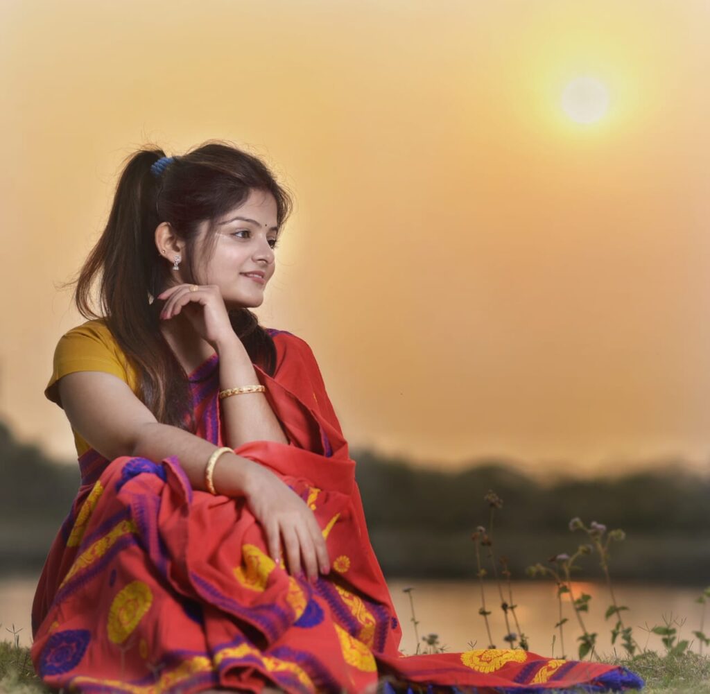 A girl sitting with a beautiful background.