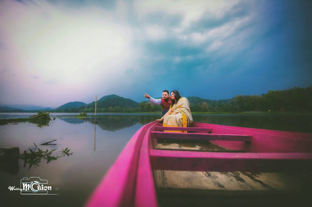 A couple in a boat with a beautiful background.