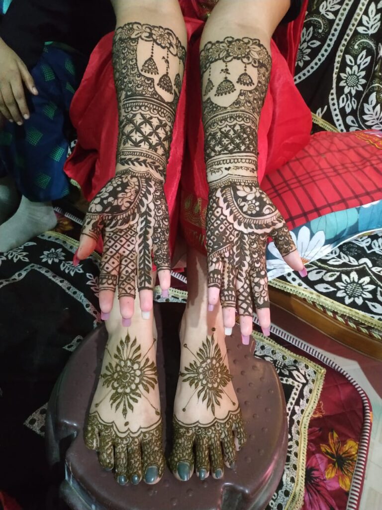 Mehndi design applied on hands and feet.