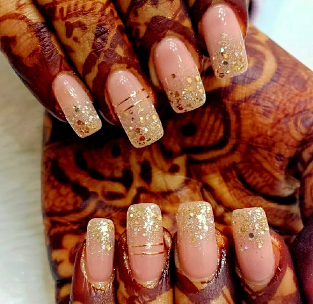 Nails adorned with glitter nail polish.