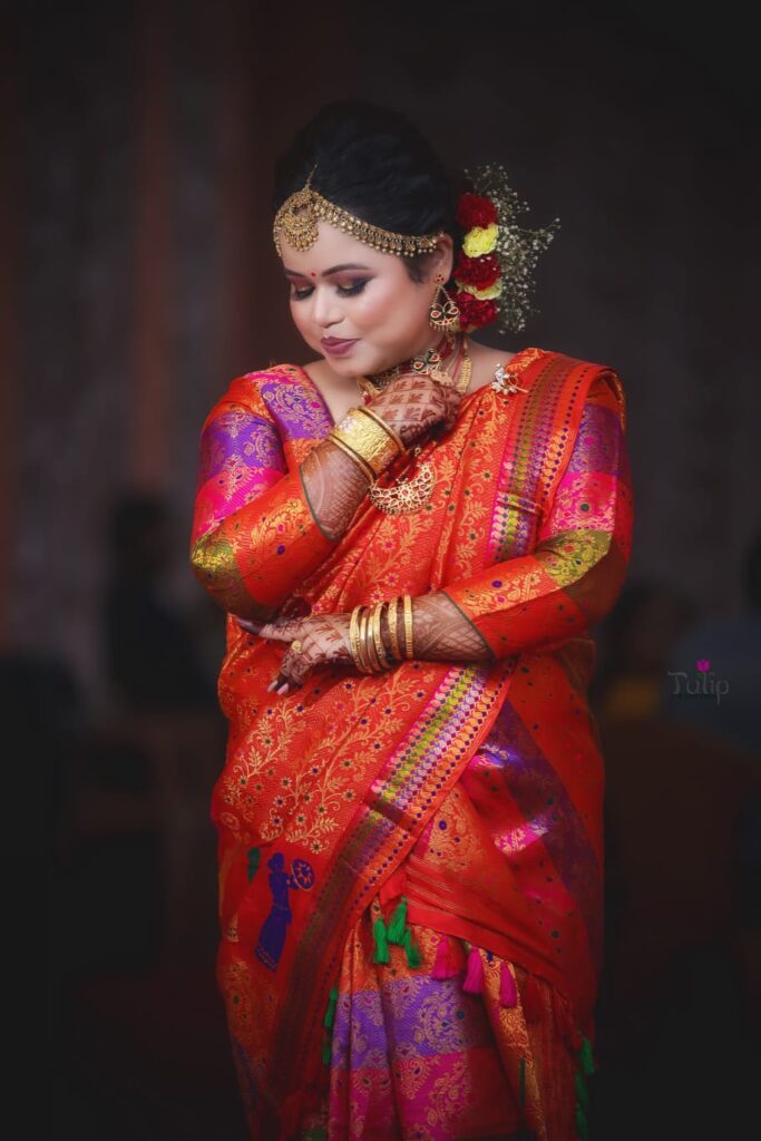Assamese girl wearing a mekhela chador and looking downwards