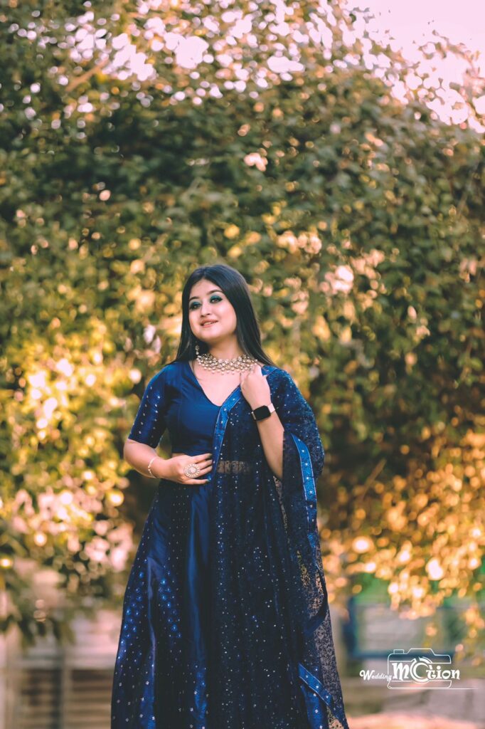 Girl wearing blue lehenga choli with stunning background.