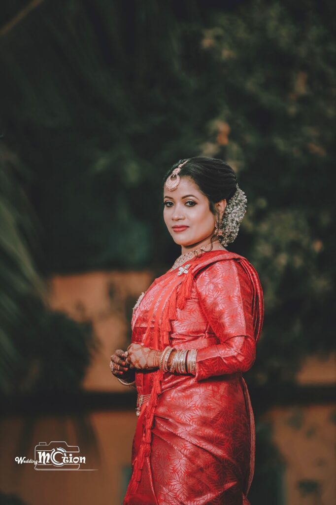 Girl wearing a red mekhela chador.