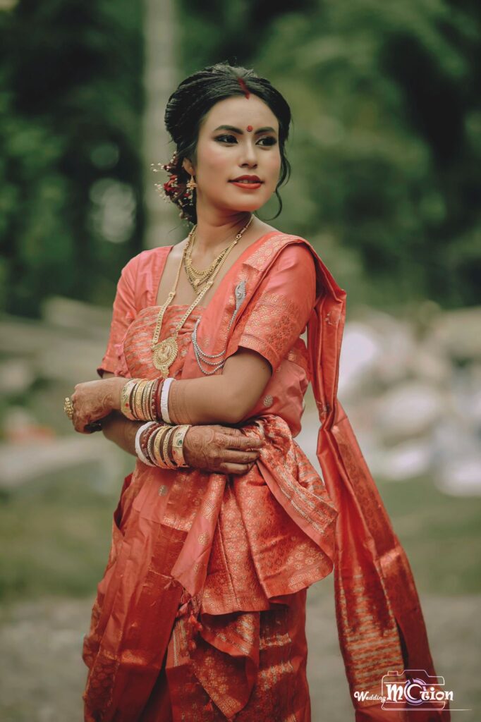 Girl wearing a mekhela chador,striking a pose for a photograph.