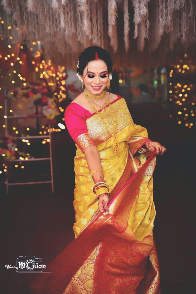 A smiling girl gracefully draping her sari pallu.
