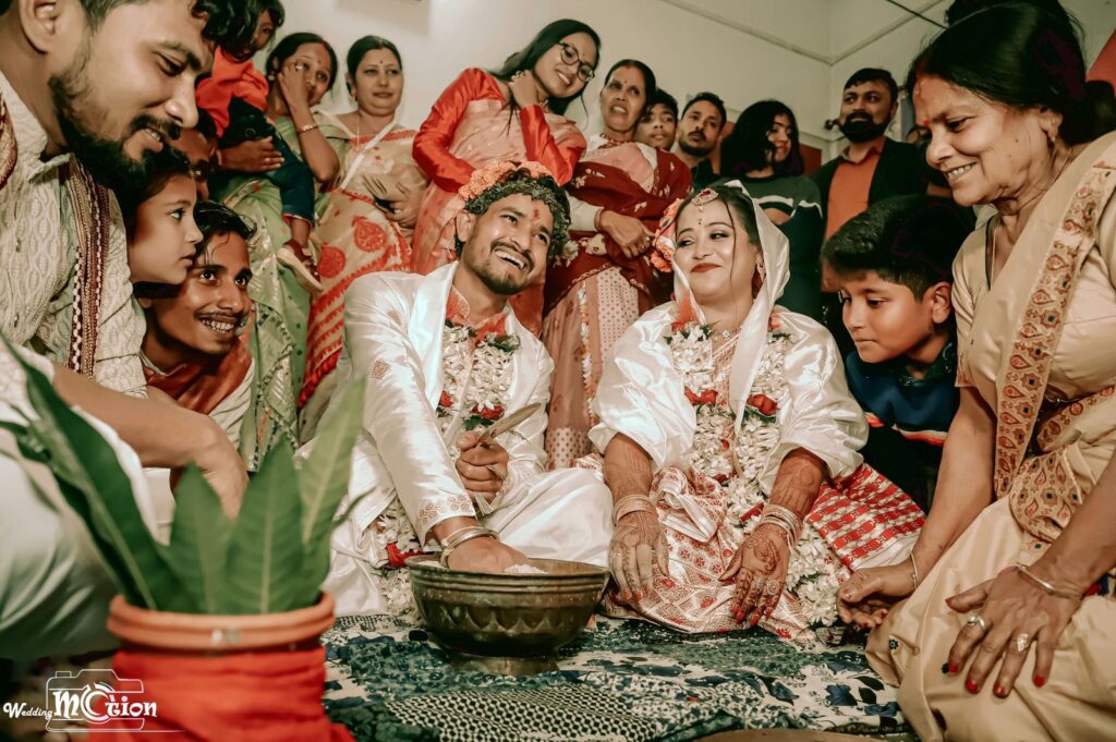 Bride and groom smiling as they perform wedding rituals.