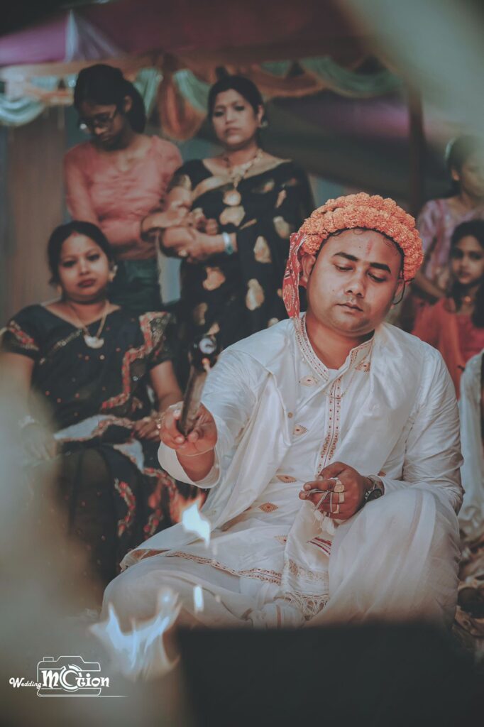 The groom performs rituals in the wedding mandap.