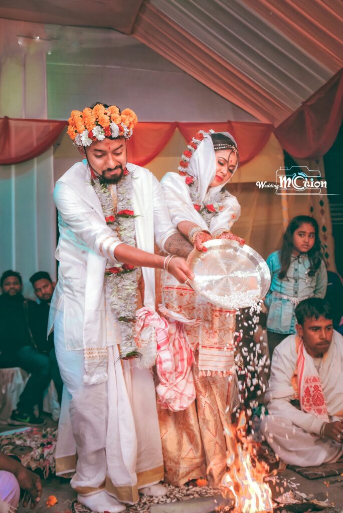 Bride and groom performing wedding rituals.